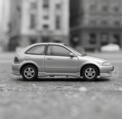 silver-toy-car-sits-grey-surface